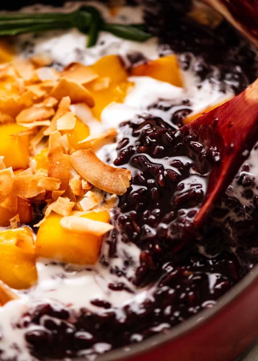 Close up of Thai Black Sticky Rice Pudding in pot with mango