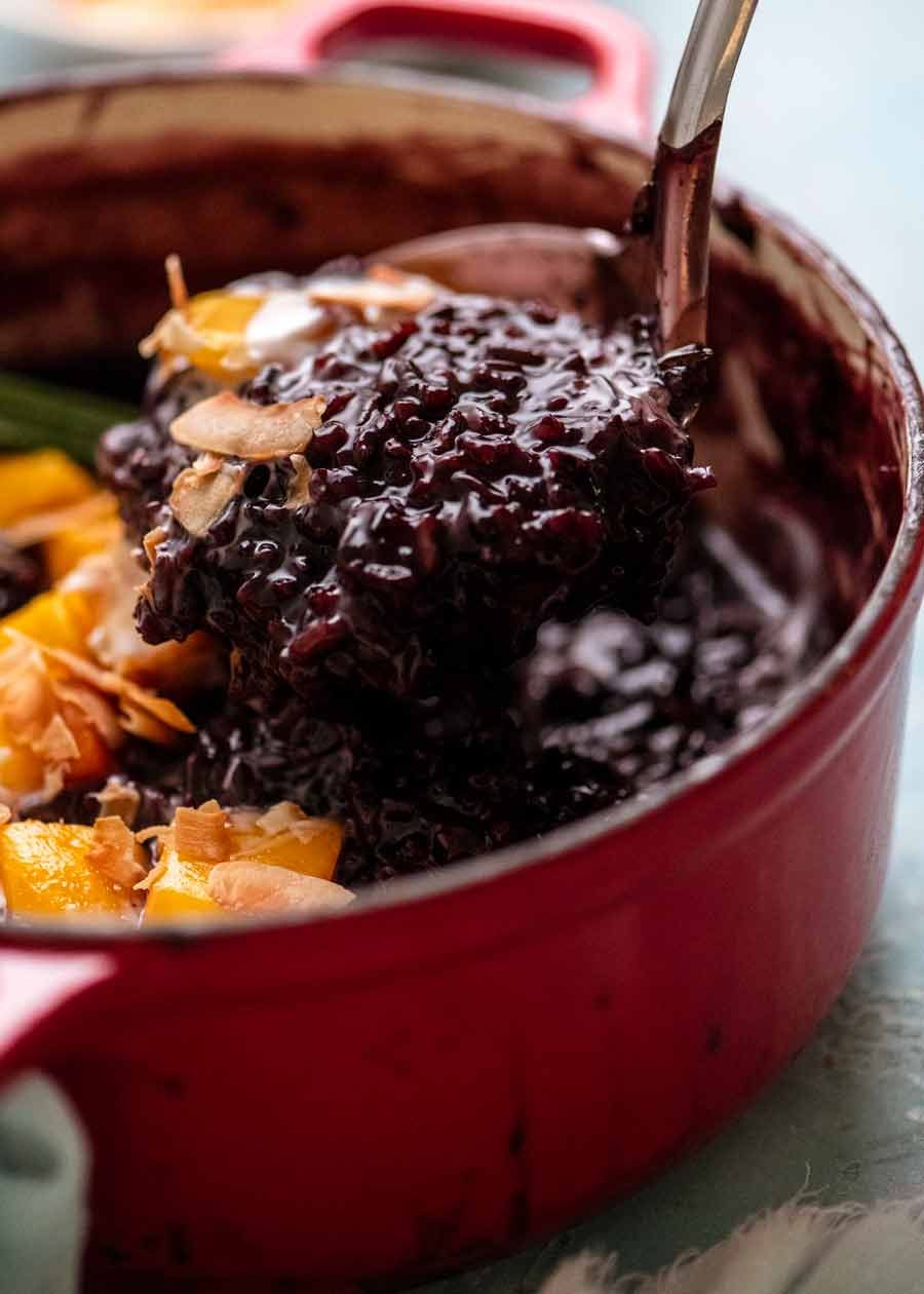 Ladle scooping Thai Black Sticky Rice Pudding