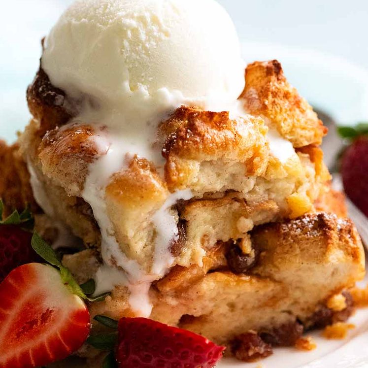 Bread and Butter Pudding in a bowl with ice cream, ready to be eaten