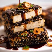 Drizzling Teriyaki Sauce over Sesame crusted Tofu Steaks with Teriyaki Sauce