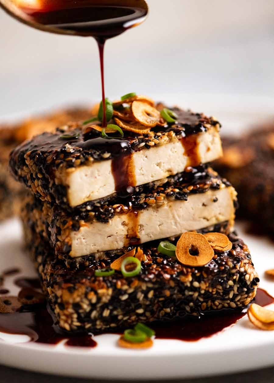 Drizzling Teriyaki Sauce over Sesame crusted Tofu Steaks with Teriyaki Sauce