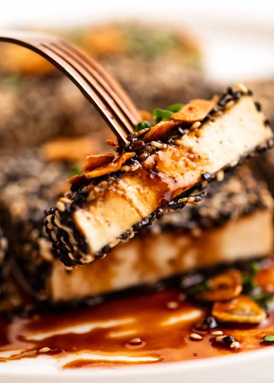 Eating Sesame crusted Tofu Steaks with Teriyaki Sauce