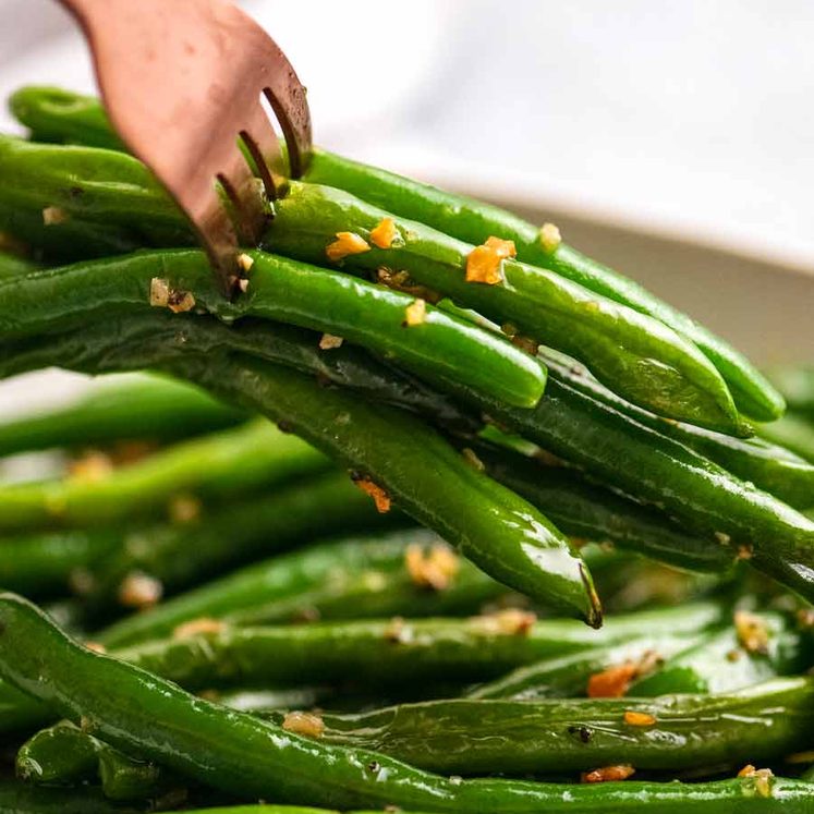 Fork picking up Garlic Sautéed Green Beans