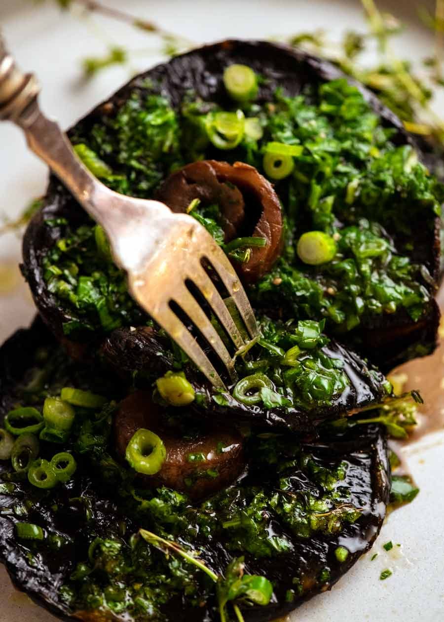 Fork picking up Roasted Large Mushrooms with Green Onion Thyme Butter