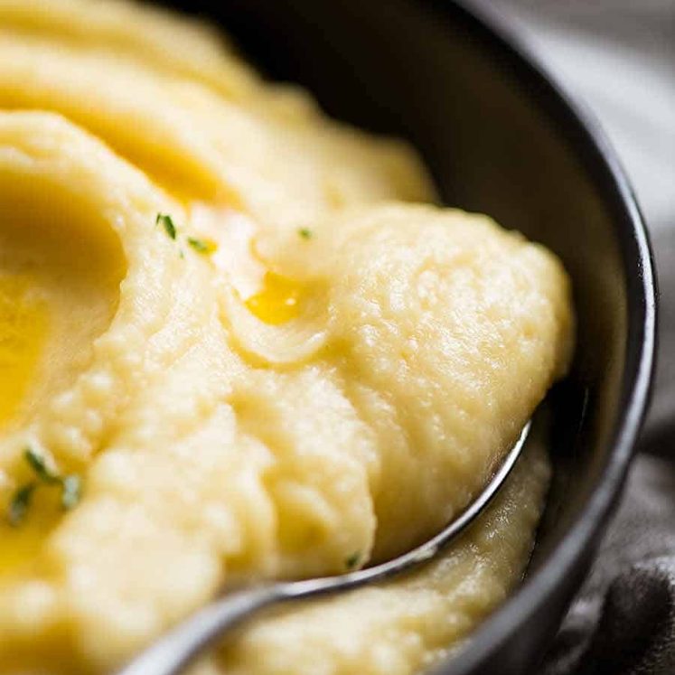 Close up of Paris Mash (Rich & Creamy Mashed Potato) being scooped up with a spoon