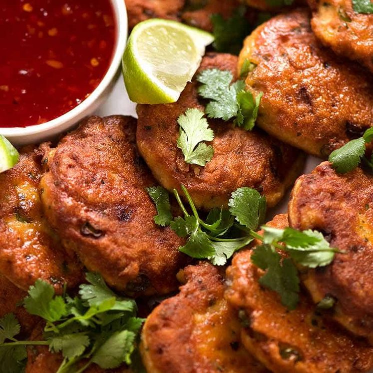 Close up photo of Thai Fish Cakes on a plate, ready to be eaten