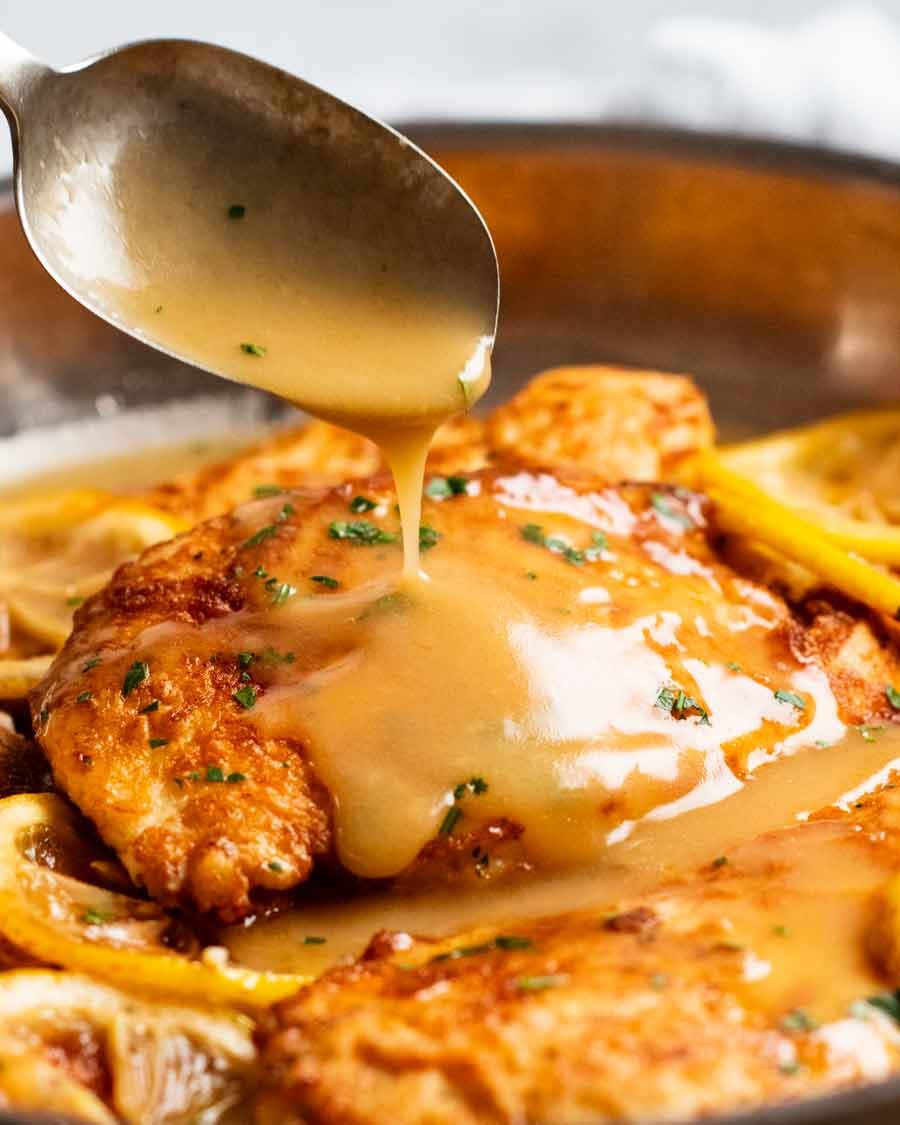 Chicken Francese sauce being poured over chicken