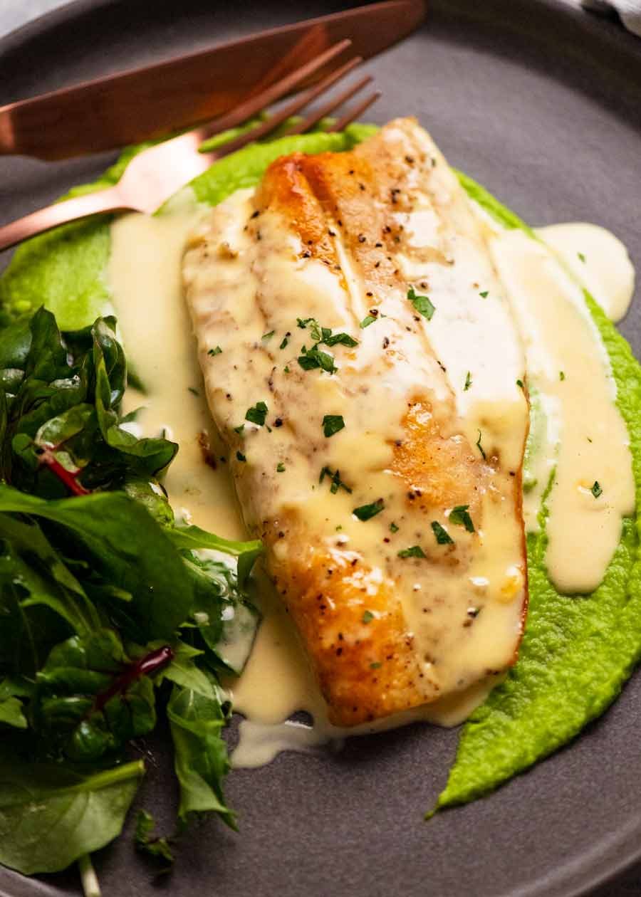 Plate with pan seared snapper on pea puree with white wine sauce