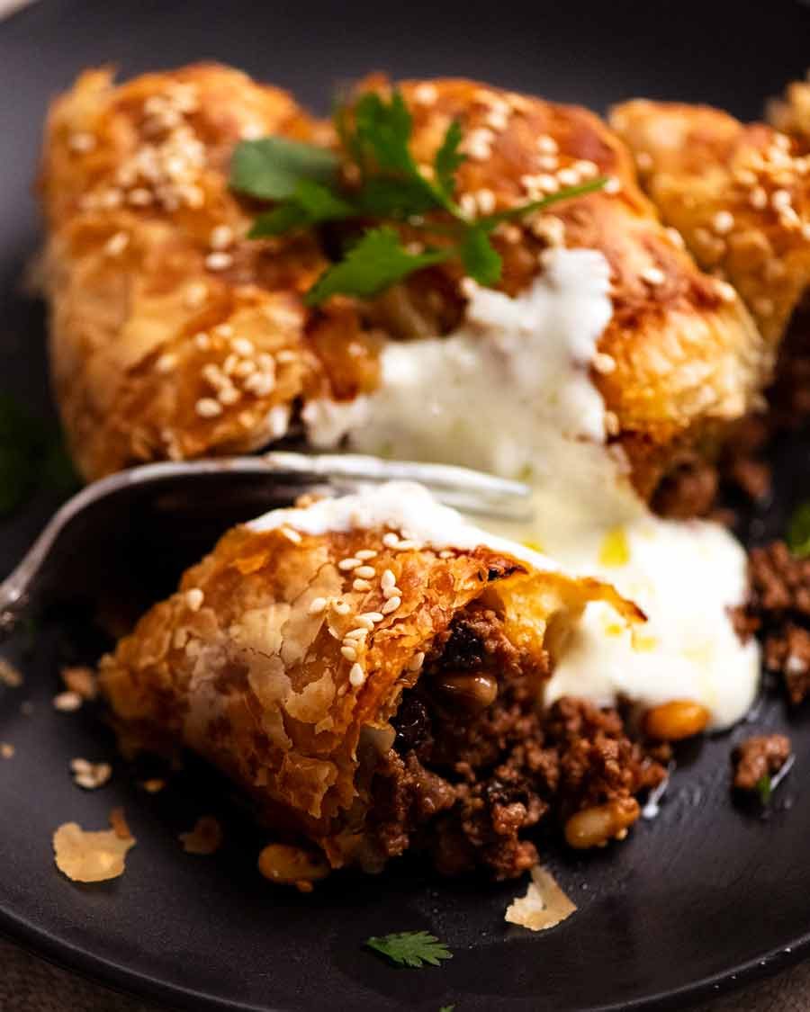 Close up of fork cutting into a slice of Borek