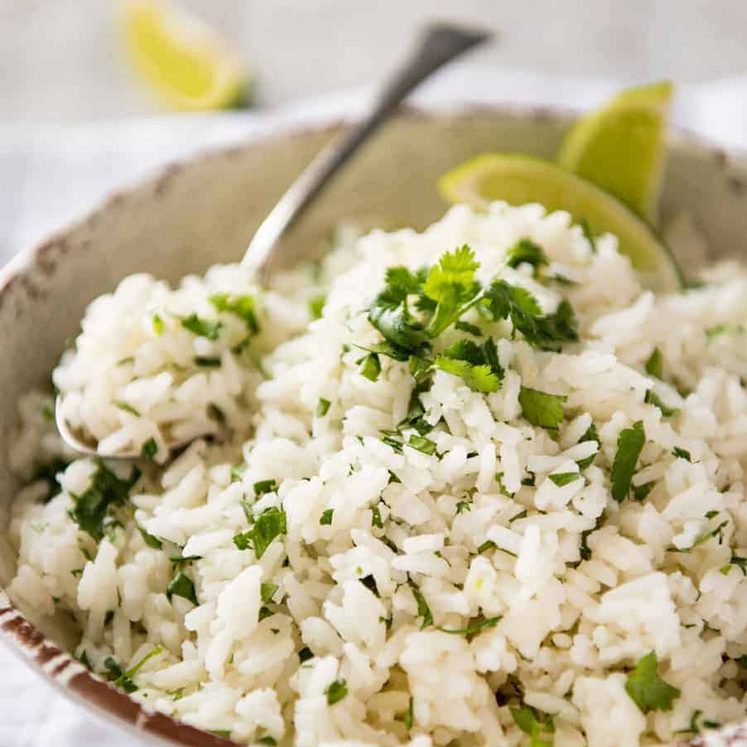 Coconut Cilantro Lime Rice in a bowl with a spoon, ready to be served.