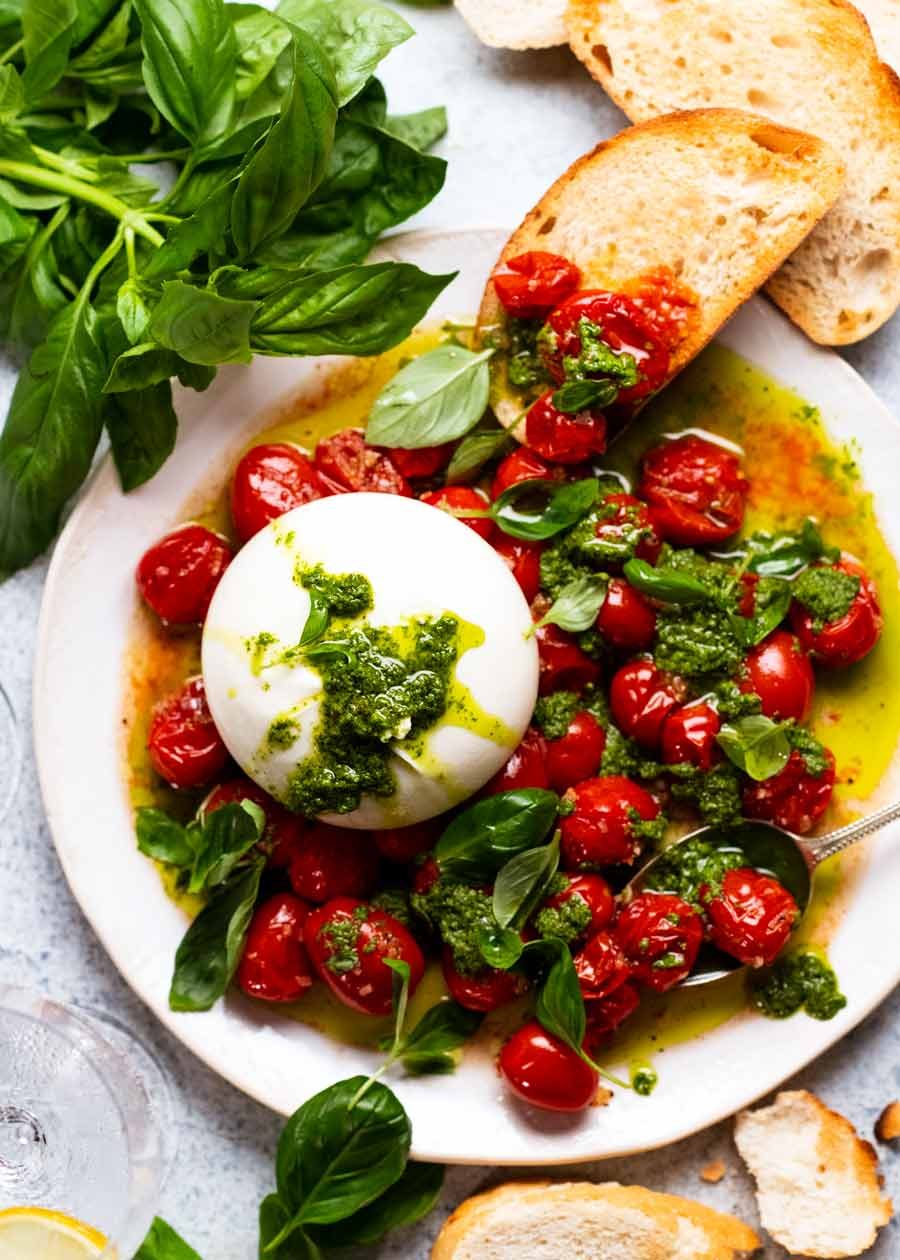 Burst tomato burrata salad ready to be eaten