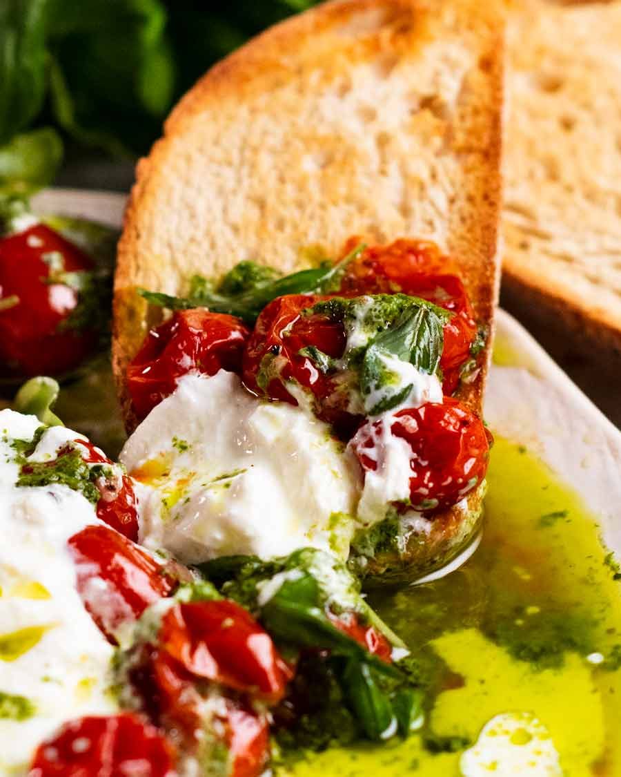 Close up of Burst tomato burrata salad