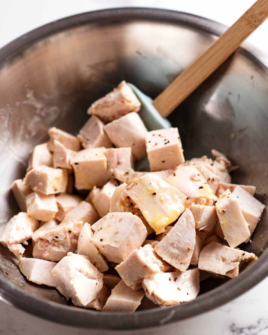 Chicken tossed in dressing for Cobb Salad