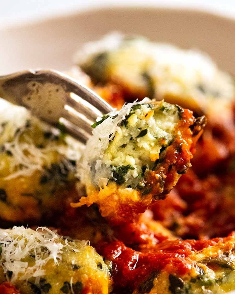 Close up showing inside of Malfatti - Italian Spinach Ricotta Dumplings