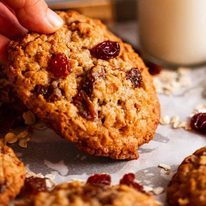 Hand picking up Oatmeal Raisin Cookies