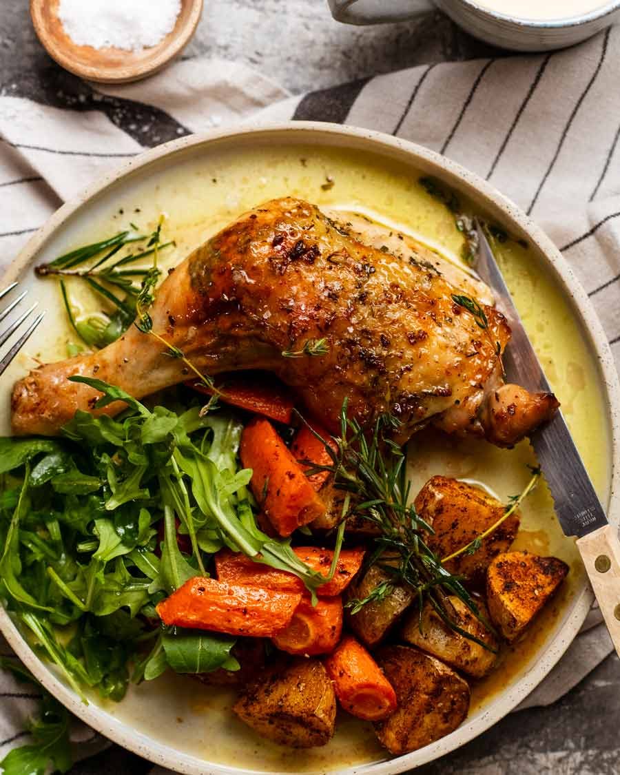 Herb & Garlic Butter Chicken Marylands on a plate with roast veg and fresh salad