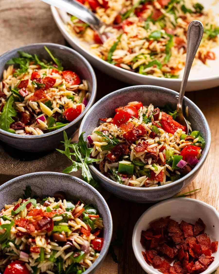 Italian risoni/ orzo salad with crispy salami bits in bowls ready to be eaten