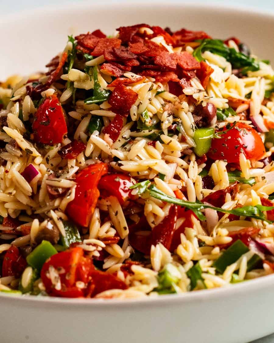 Pile of Italian risoni/ orzo salad with crispy salami bits