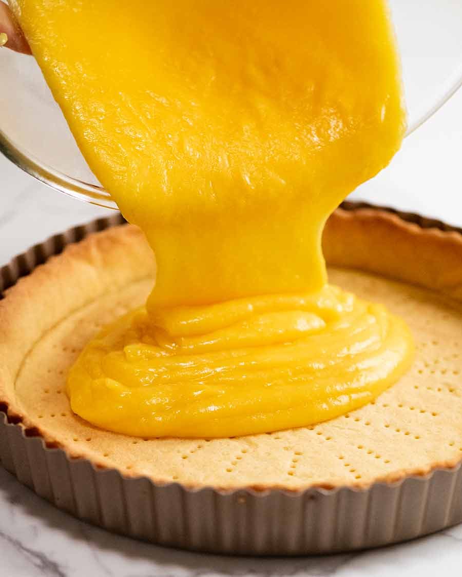 Pouring lemon curd into Lemon Tart crust