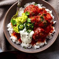 Overhead photo of Mexican Meatballs served with guacamole and sour cream over rice