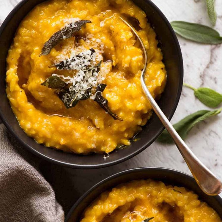 Overhead photo of two black bowls with Creamy Baked Pumpkin Risotto