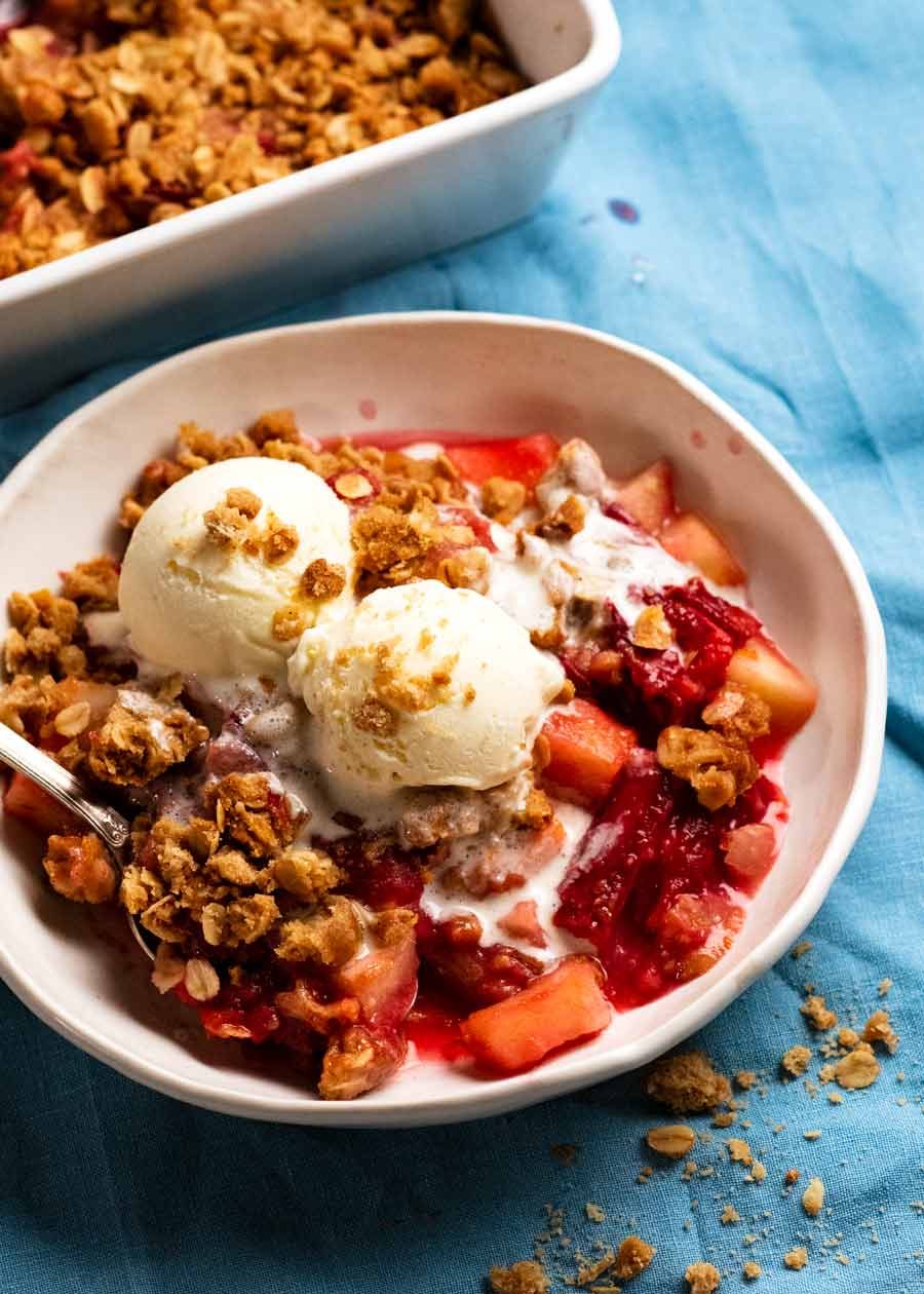 Bowl of Rhubarb crumble with apple with ice cream