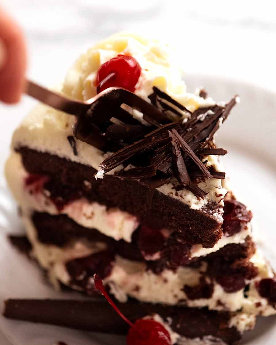 Fork cutting into a slice of Black Forest Cake