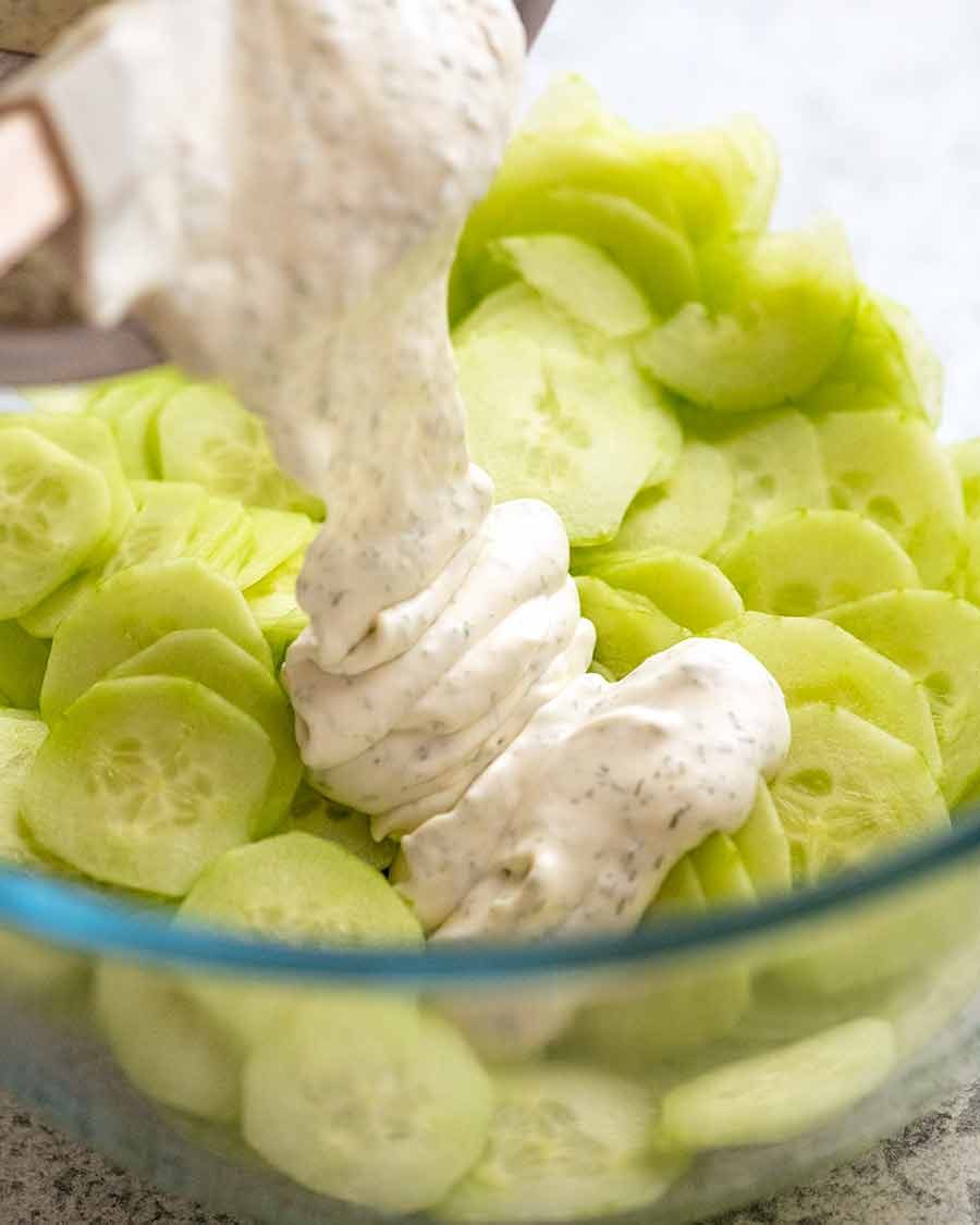 Pouring dressing over German Cucumber Salad