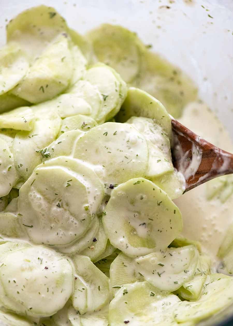 Mixing German Cucumber Salad in a bowl