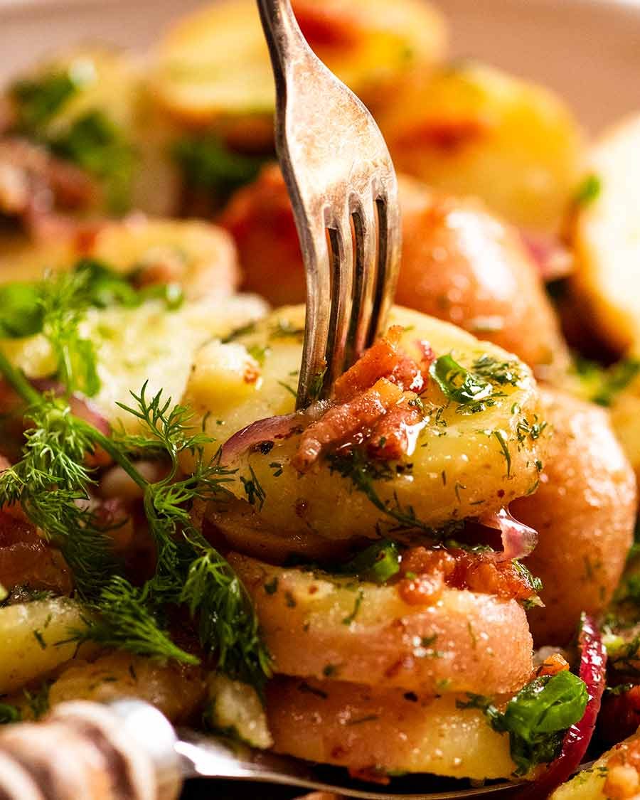 Close up of fork picking up a piece of German Potato Salad