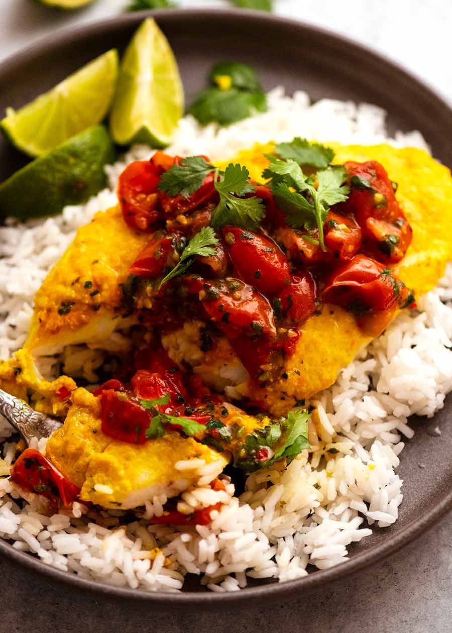 Golden Turmeric Fish (Indonesian) served on white rice, ready to be eaten