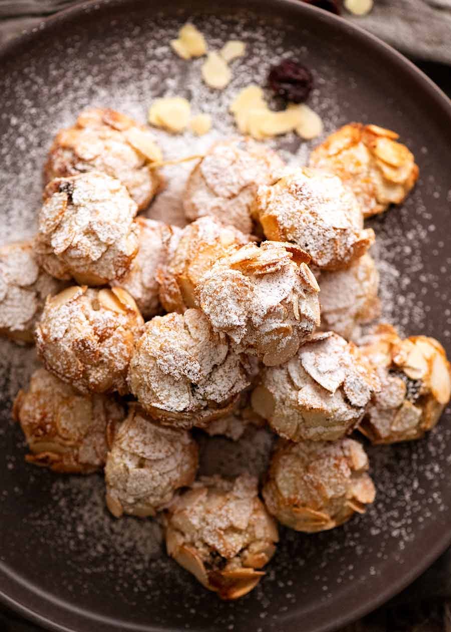 Overhead photo of Italian Almond Cookies on a plate, dusted with icing sugar