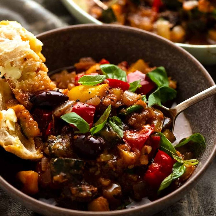 Ratatouille in a bowl with a side of crusty bread