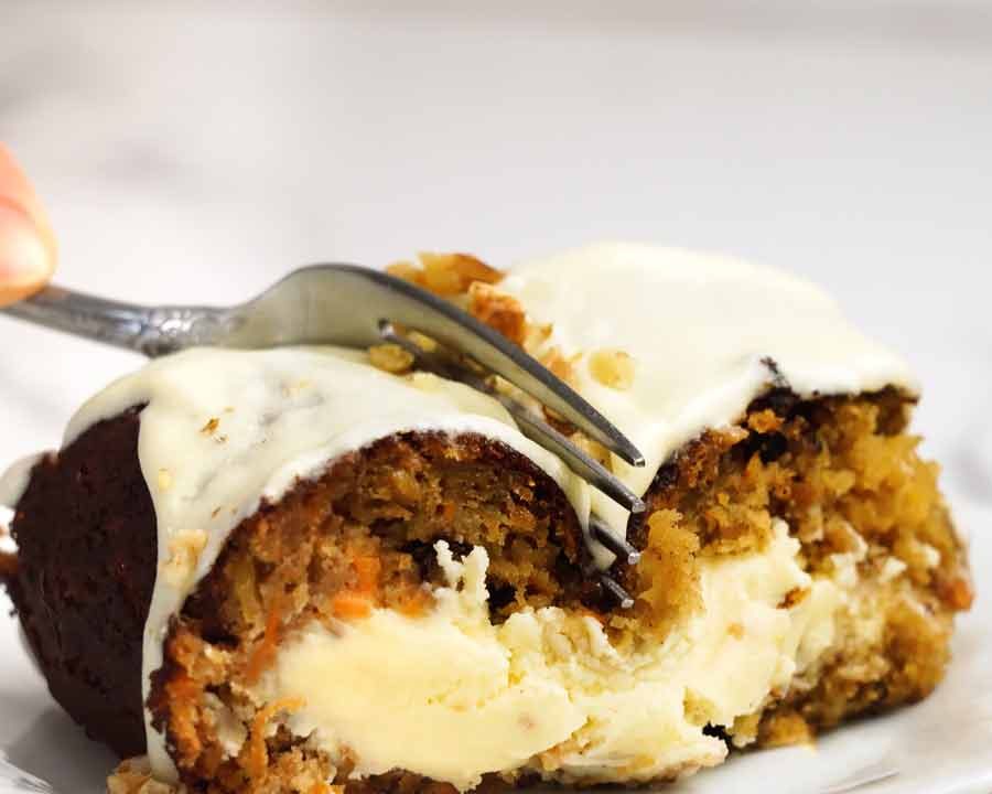 Fork cutting into Cheesecake stuffed carrot bundt cake