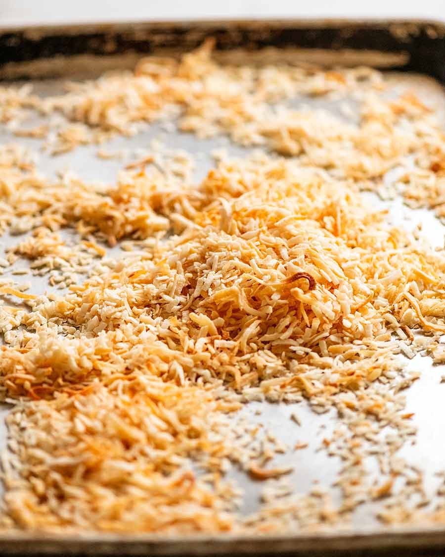 Toasted coconut flakes on a tray to be used for Easter Cake decorating