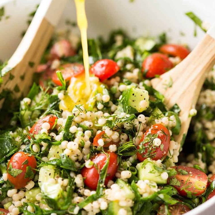 This Israeli Couscous Salad is fabulously addictive! Tender, flavour infused beads of couscous tossed with spinach, tomato, cucumber, herbs and a fresh lemon dressing. Summer in a bowl! recipetineats.com