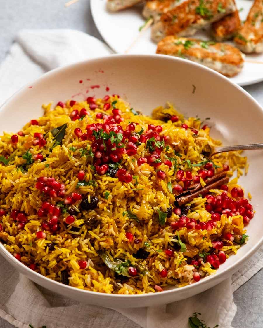 Platter of jewelled rice with fish koftas on the side