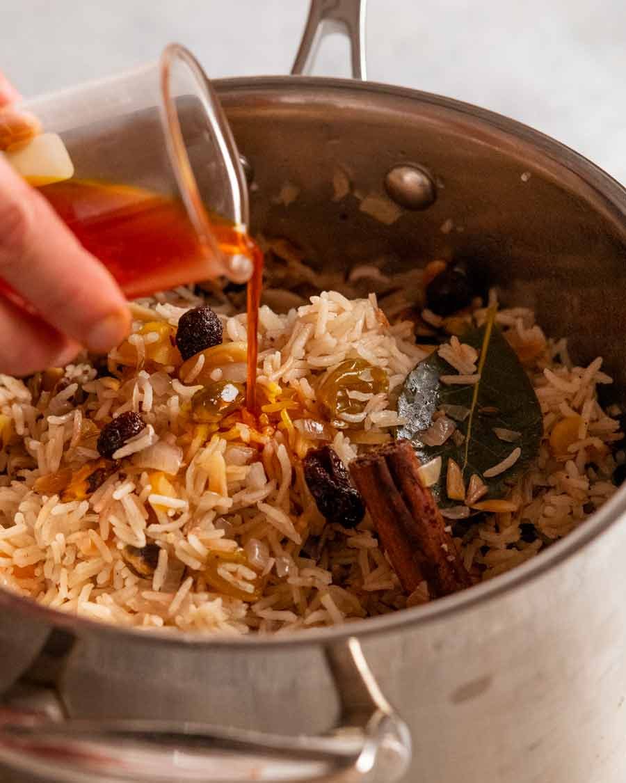 Pouring saffron water onto Jewelled rice pilaf