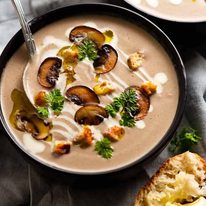 Bowl of Mushroom Soup garnished with golden mushrooms