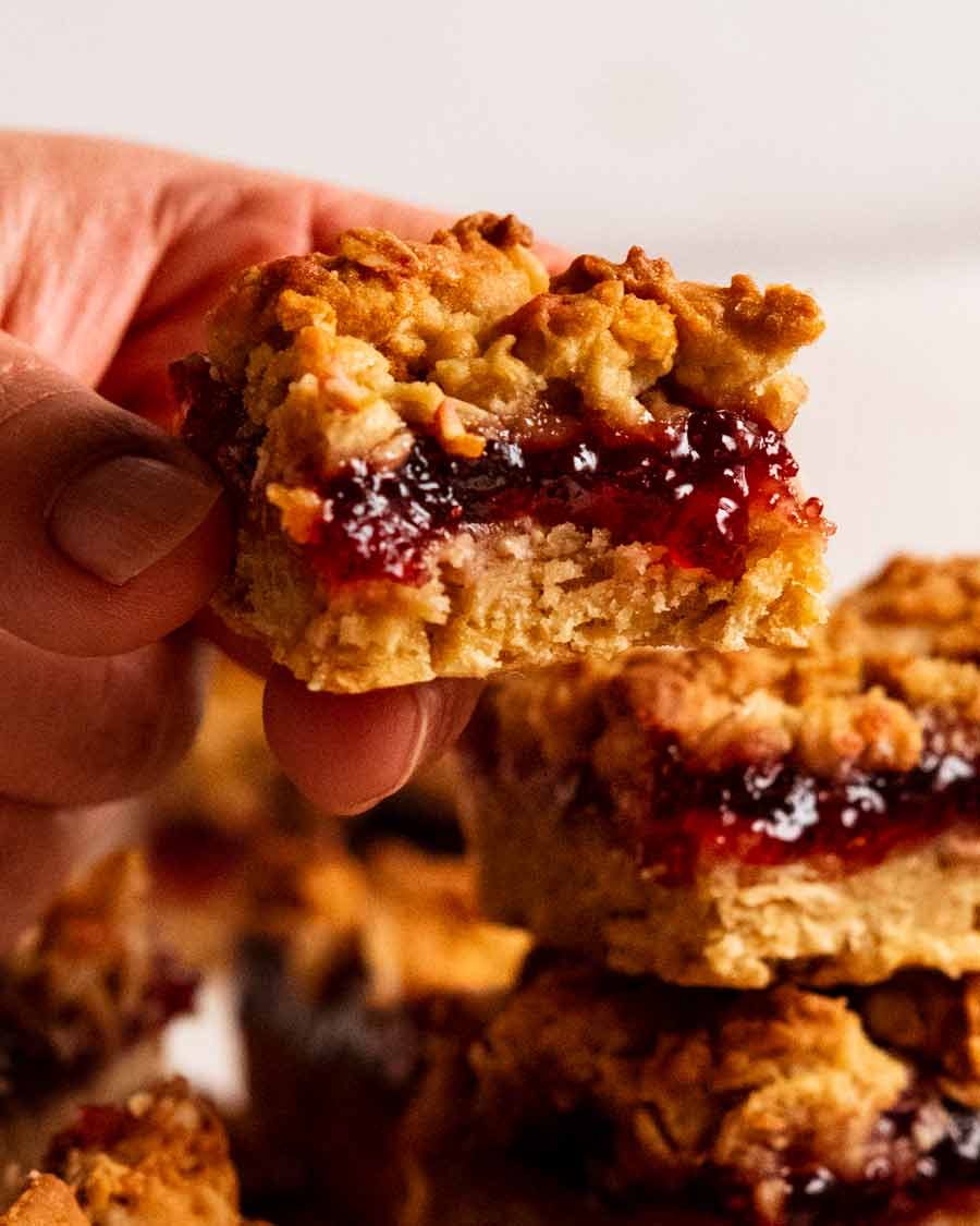 Hand holding Raspberry jam oat bar