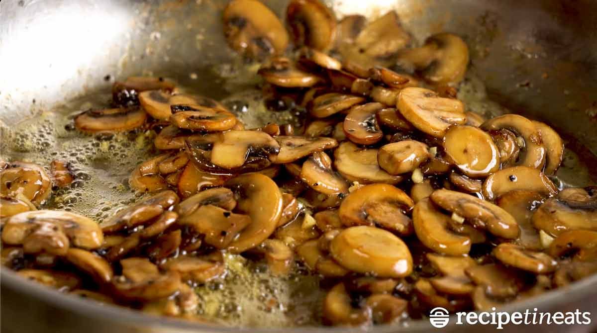 Buttery garlic sautéed mushrooms in a skillet