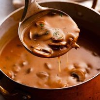 Ladle scooping up Mushroom Gravy