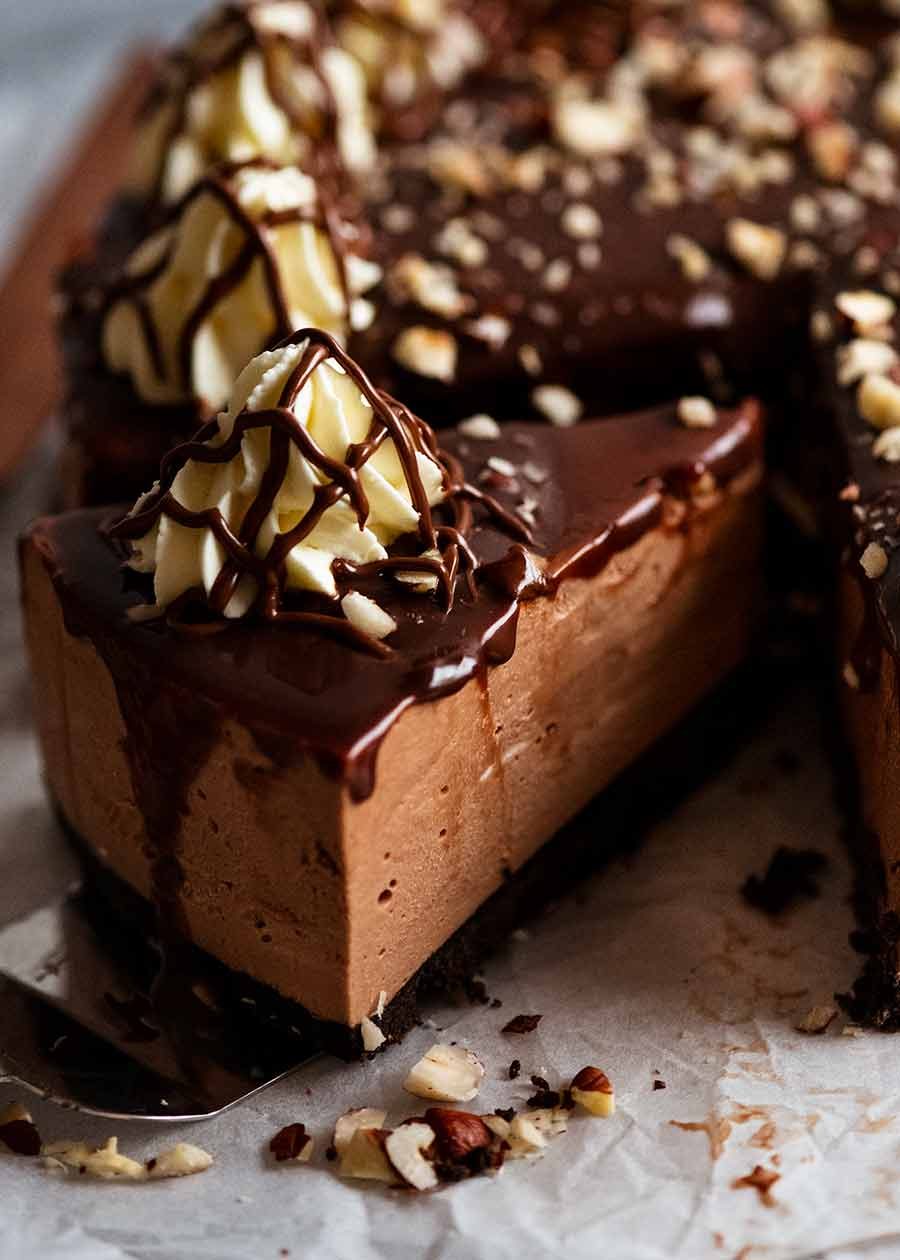 Close up of a slice of Nutella Cheesecake (No Bake) being pulled out