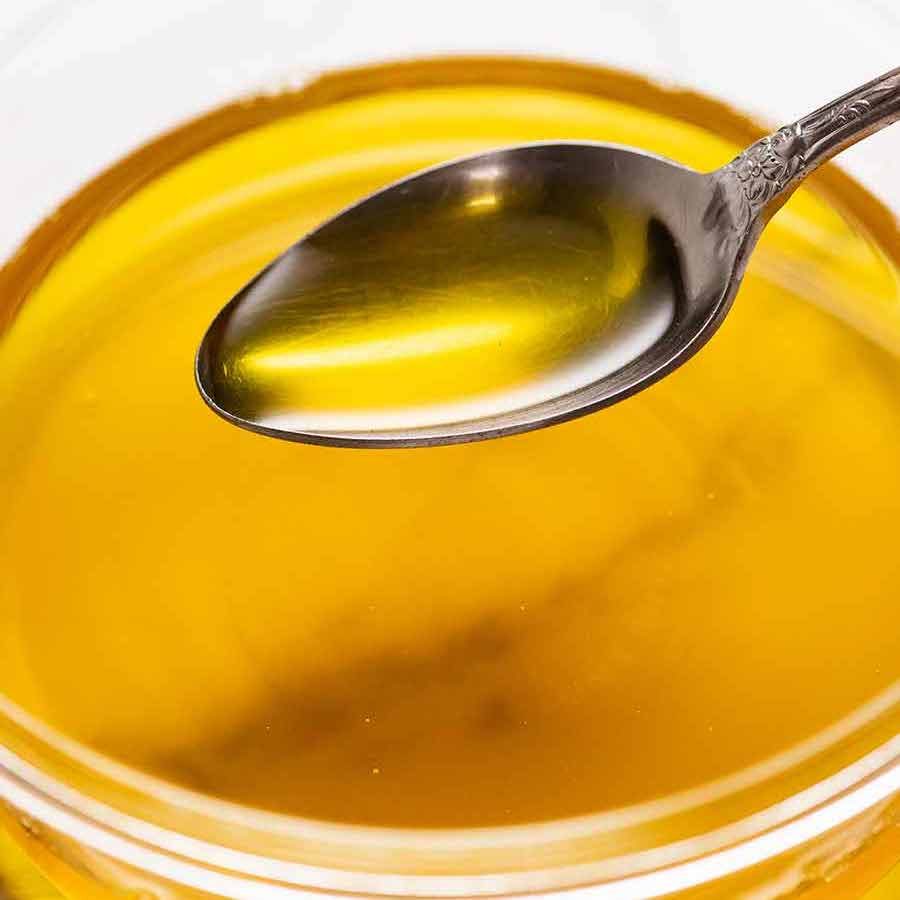 clarified-butter-and-ghee_6-sq-1 Spoon scooping up homemade ghee