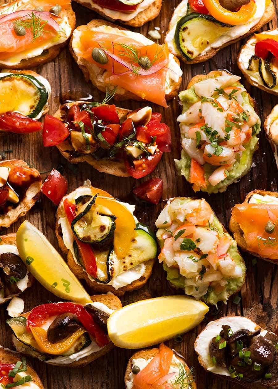 crostini-on-wooden-board-1 Wooden board filled with Crostini - Smoked Salmon, Shrimp Avocado, Mediterranean and Caprese