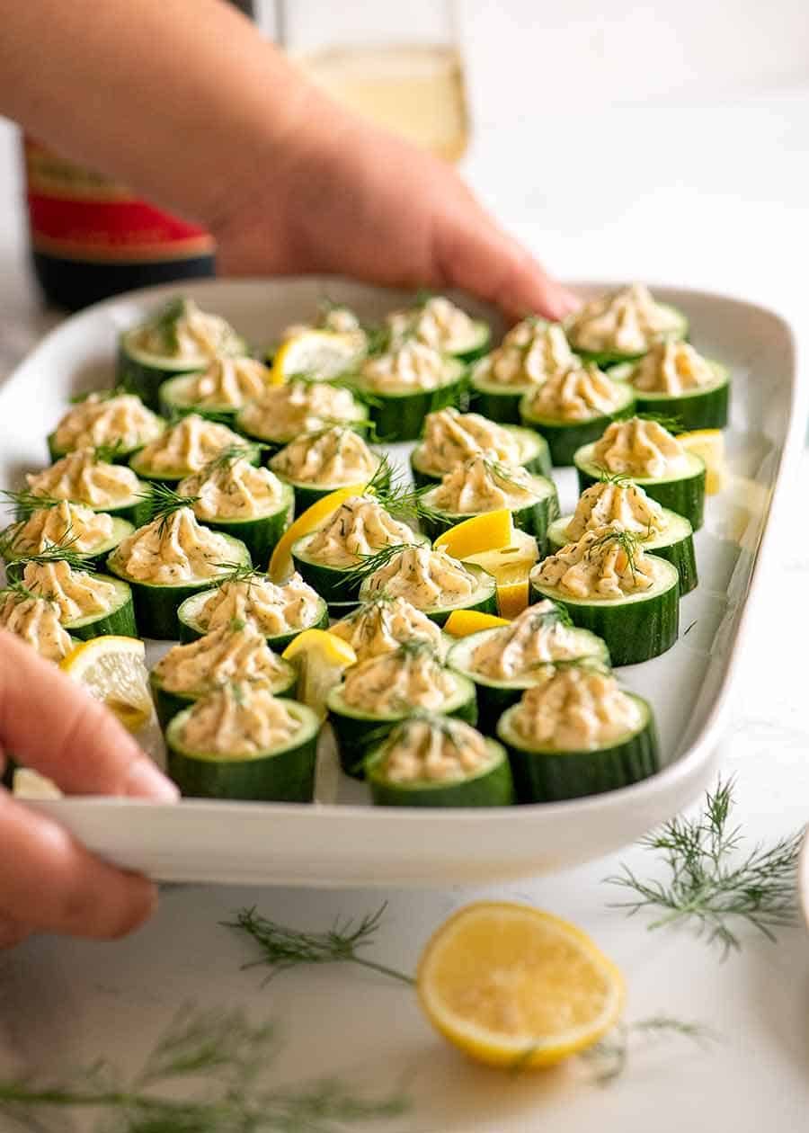 cucumber-canapes-with-smoked-salmon-mousse_7-copy Platter of cucumber appetisers topped with smoked salmon mousse