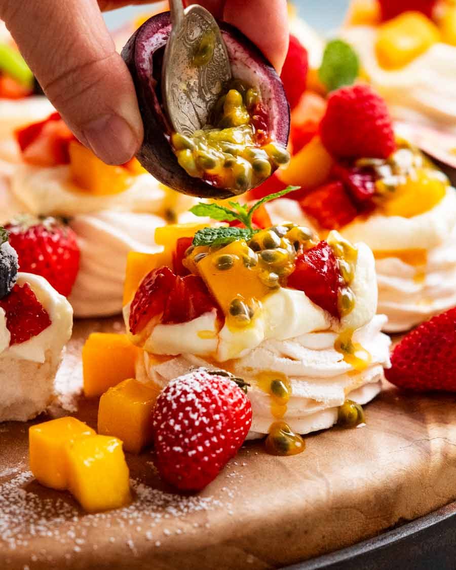 mini-pavlovas_4 Putting passionfruit topping on Mini Pavlovas