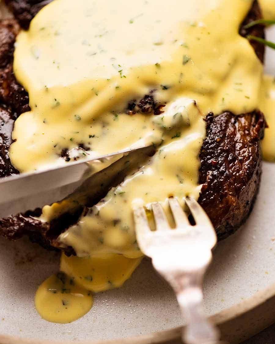 steak-with-bearnaise-sauce-3 Close up of knife cutting into steak with Bearnaise Sauce