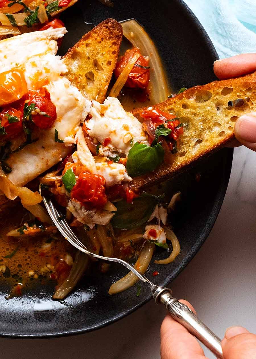 acqua-pazza_7 Fork piling Acqua Pazza Italian Poached Fish on a crispy garlic crostini