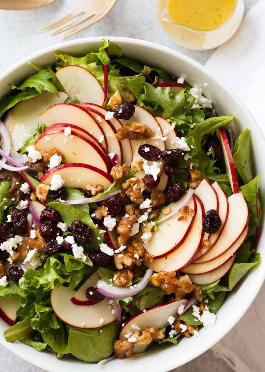 apple-salad-with-candied-walnuts-cranberries_2-2 Overhead photo of Apple Salad with Candied Walnuts and Cranberries with vinaigrette dressing on the side